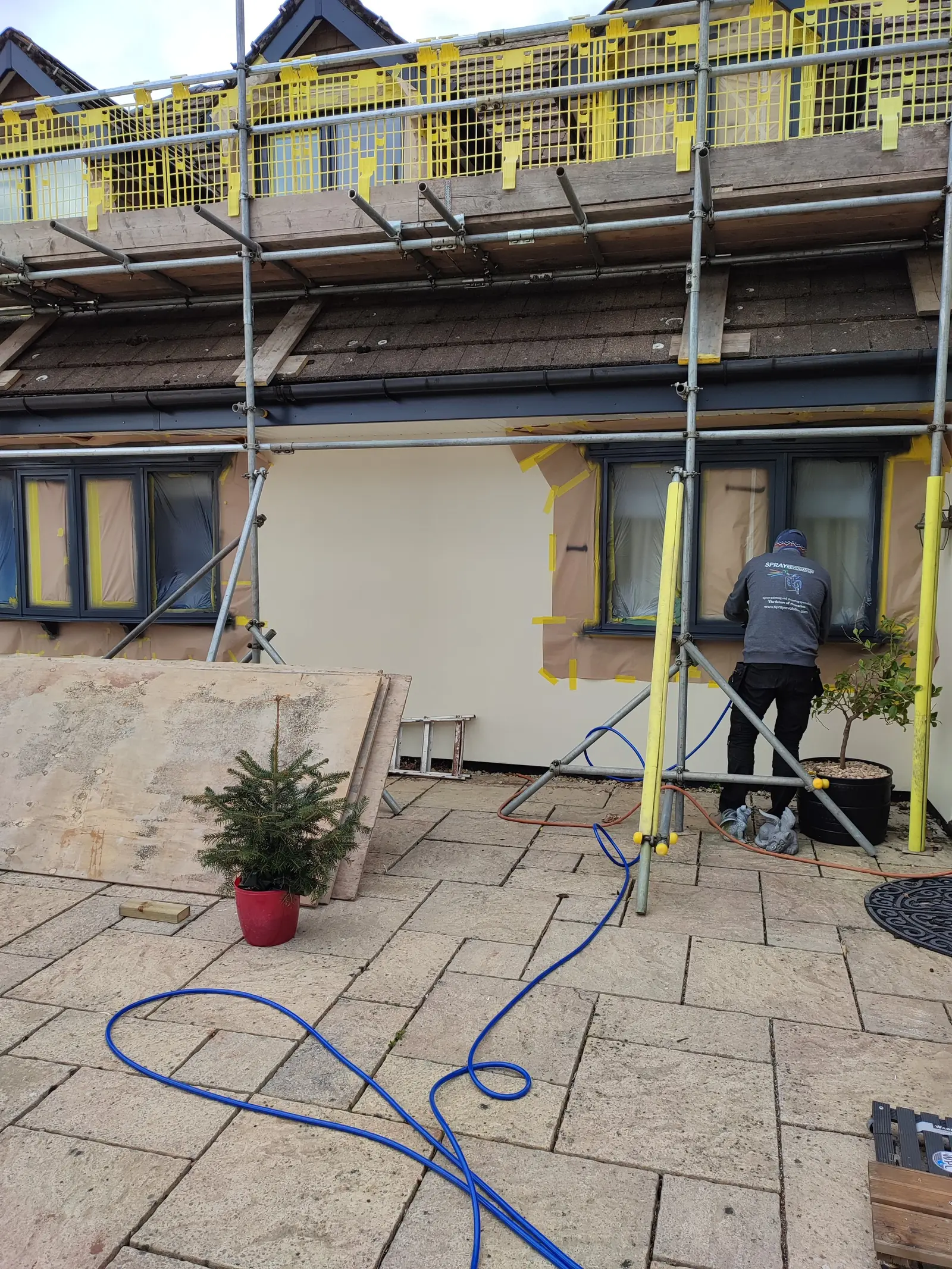 House under renovation with protective tape on windows